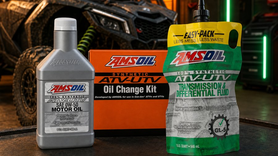 AMSOIL ATV and UTV motor oil, oil change kit, and transmission fluid in an off-road garage