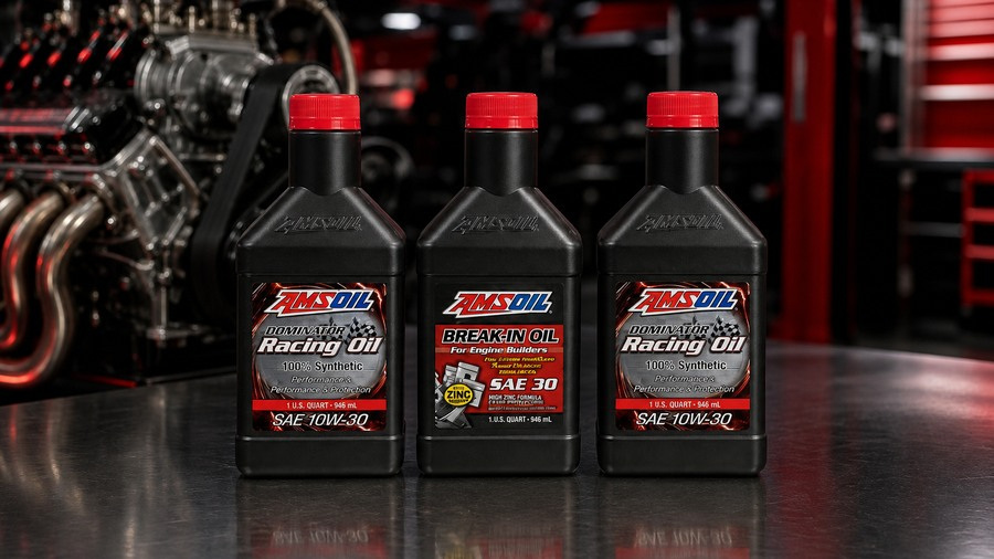 AMSOIL DOMINATOR Racing Oil and SAE 30 Break-In Oil bottles in a race shop